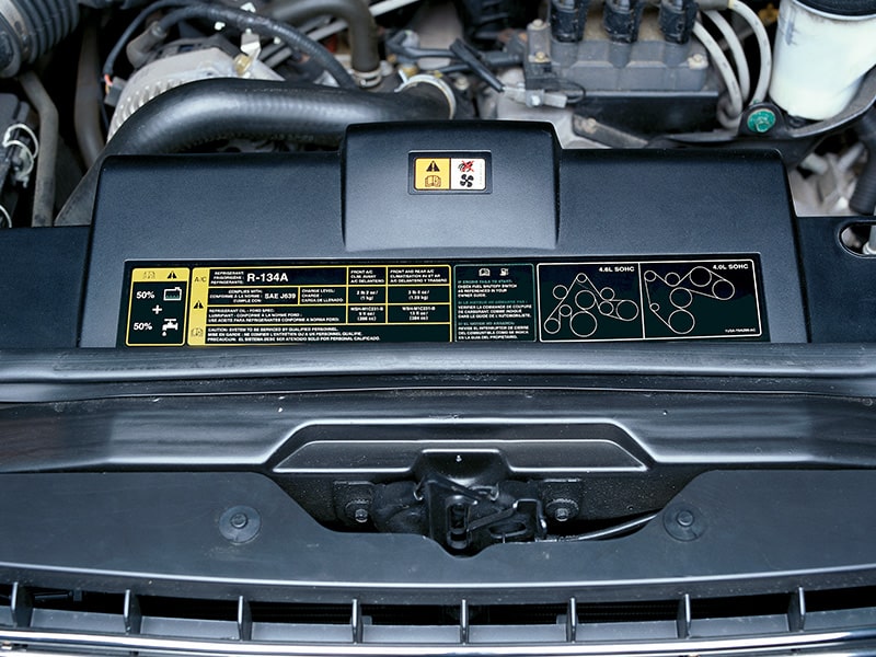 An engine bay with various labels attached to parts