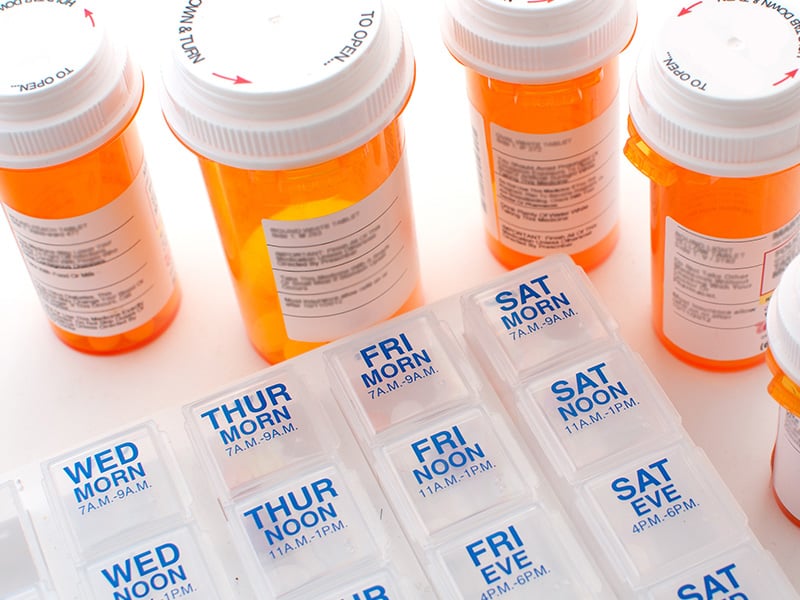 Various healthcare medicine containers with labels attached