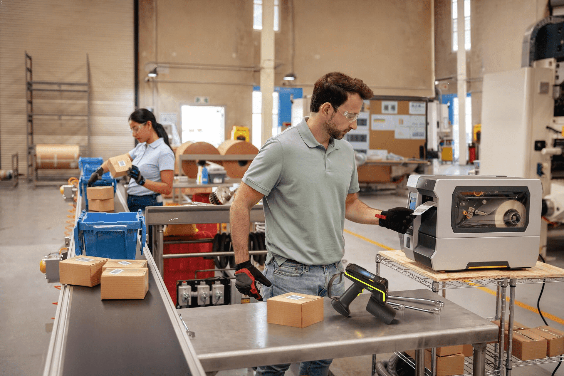 A manufacturing plant floor with staff using labels printers, applying labels and using barcode scanners